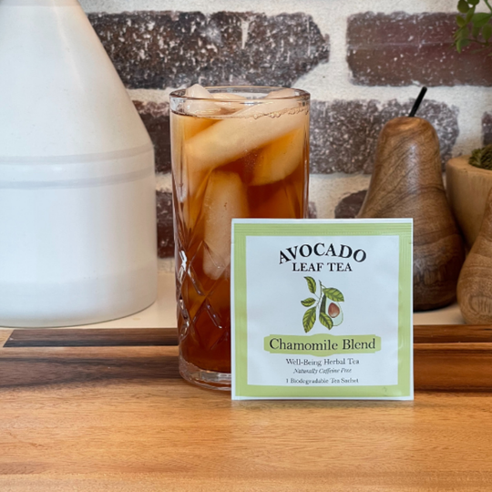 Single serve avocado leaf chamomile blend tea next to an iced tea in a glass.