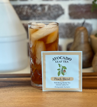 Single serve avocado leaf Peach blend tea next to an iced tea in a glass.