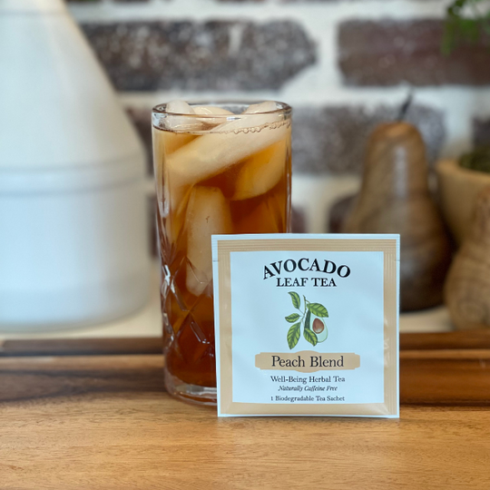 Single serve avocado leaf Peach blend tea next to an iced tea in a glass.