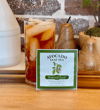 Single serve avocado leaf tea next to an iced tea in a glass.